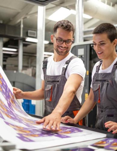 Press Operators Examining Printed Banner